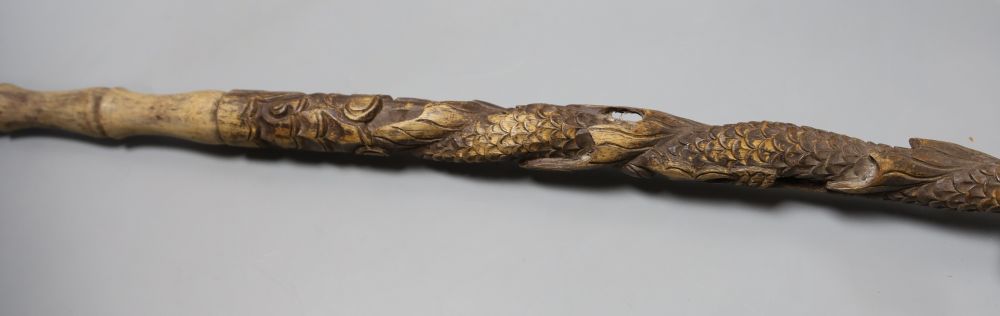 Three Chinese carved wood walking sticks, largest 108cm